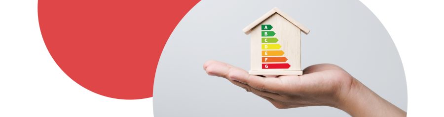 Hand holding model house with EPC ratings